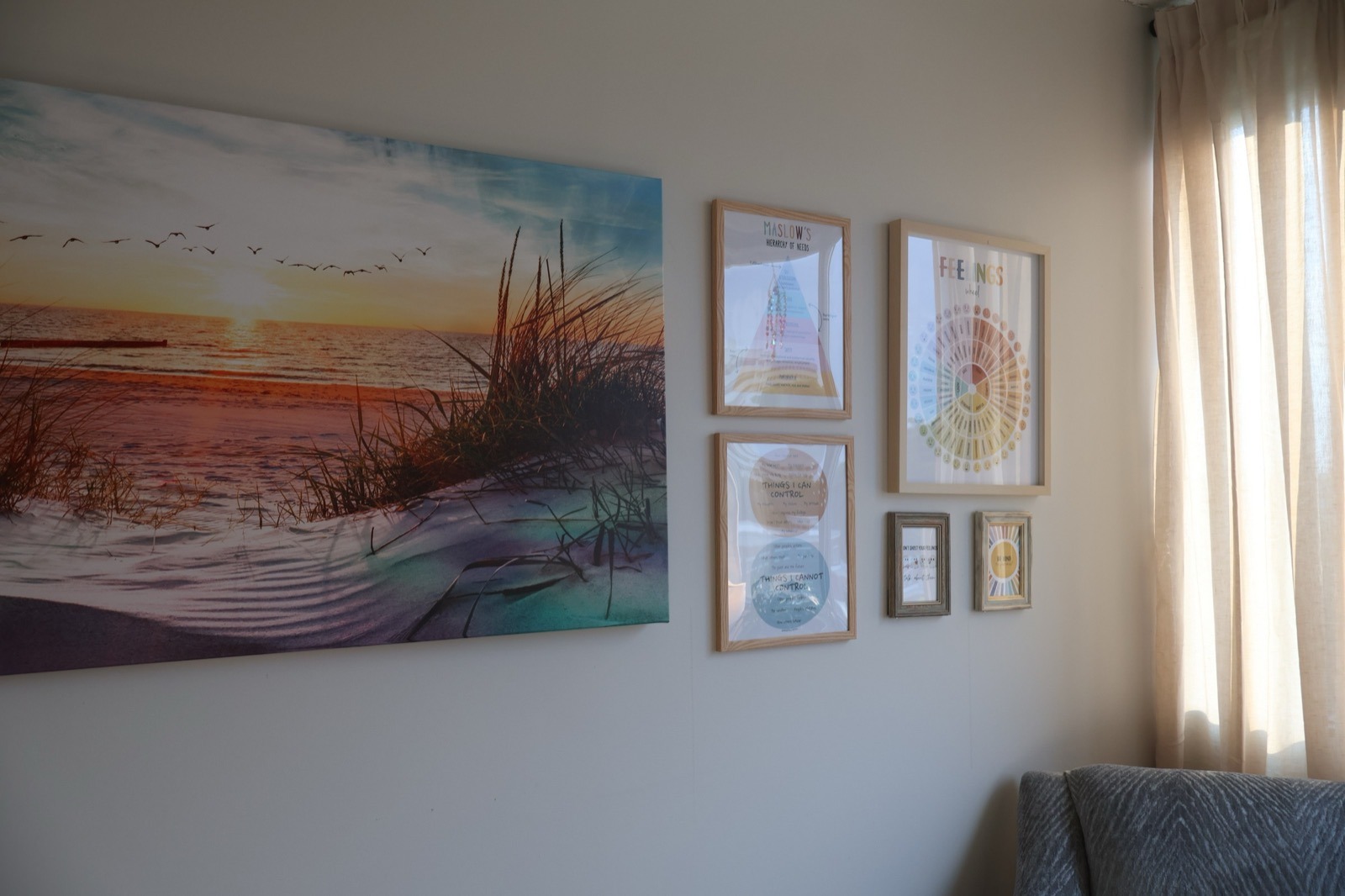 A calming beach photo and feelings-wheel artwork on the wall at Our Place